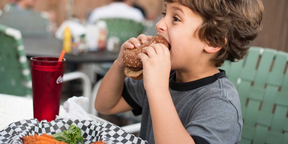 boy eating a hamburger