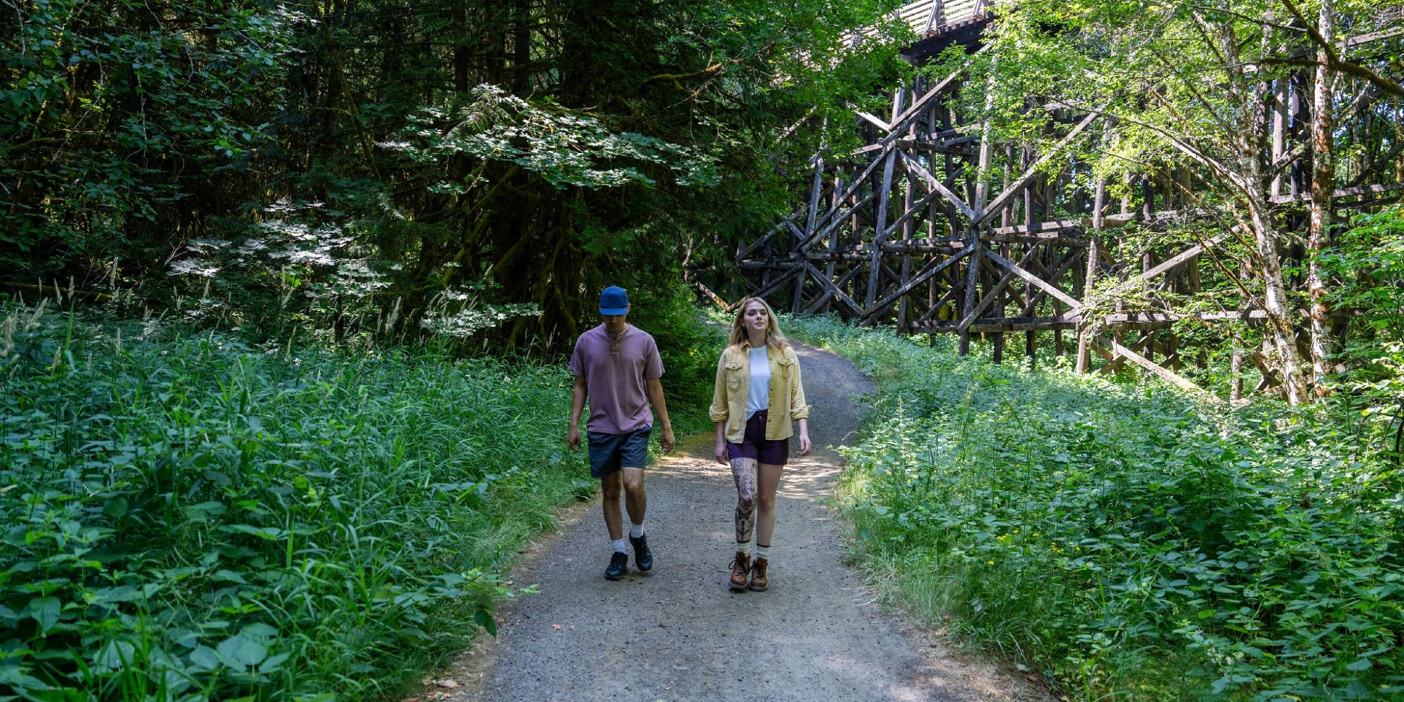 A man and a woman hiking along a trail in Tualatin Valley
