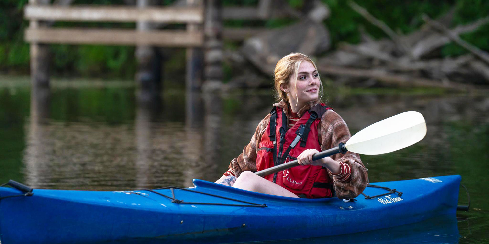 young woman is kayaking on the Tualatin River