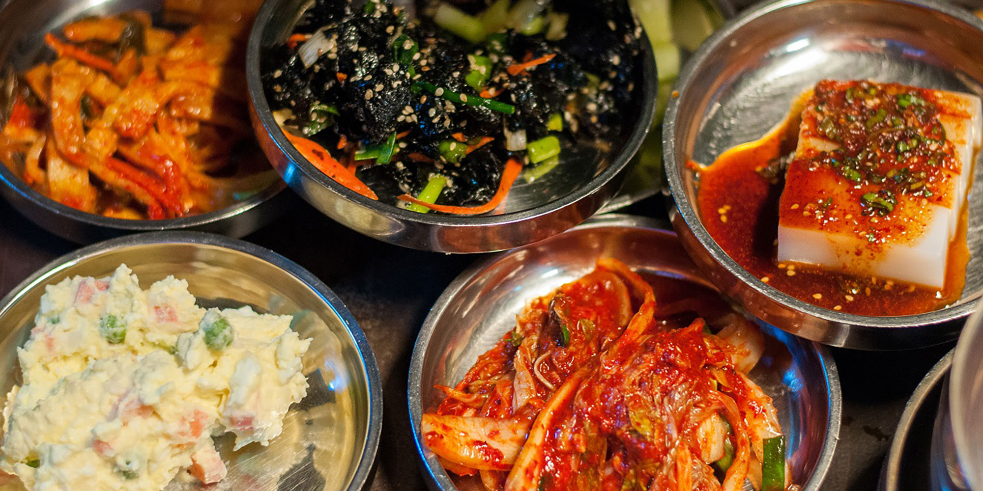 variety of korean food in bowls