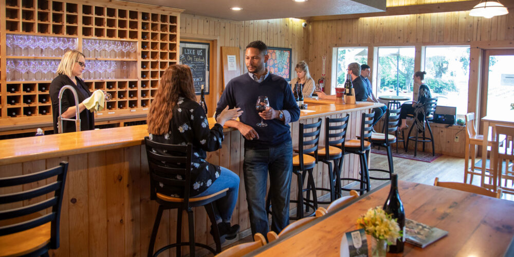 couple tasting wines in a tasting room at Tualatin Estate Vineyard