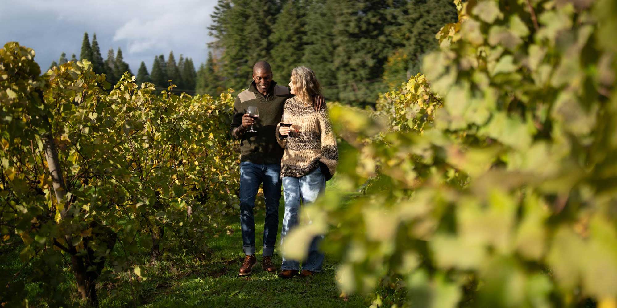 couple enjoying a glass of wine in a vineyard