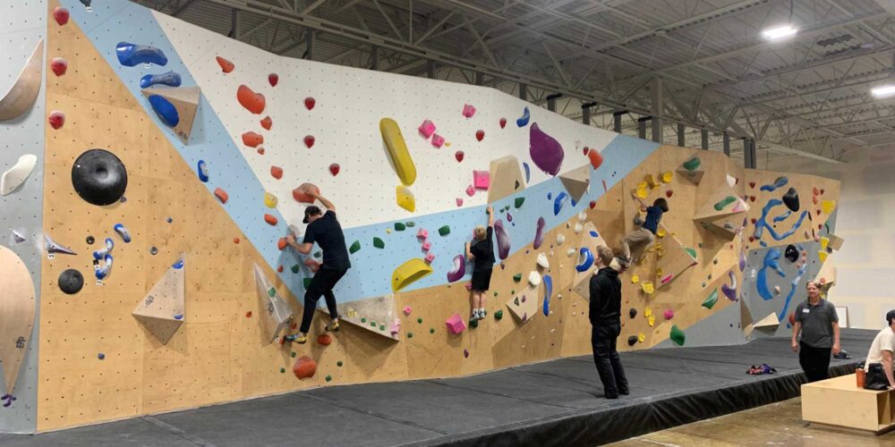 people on a climbing wall