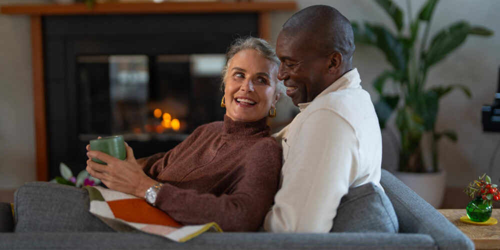 a couple enjoying a cozy moment in front of a fire