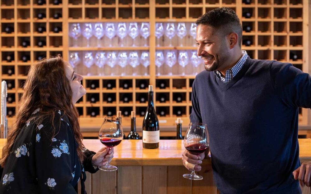 a couple enjoying a glass of wine in a tasting room