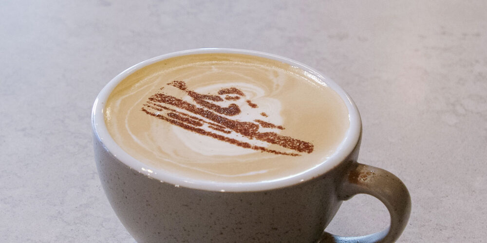 cup of coffee with a shoe pattern on top of the foam