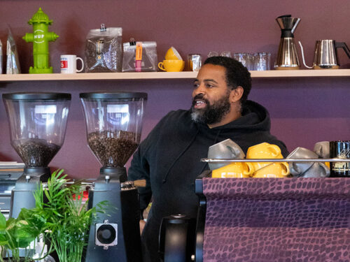 man behind coffee counter