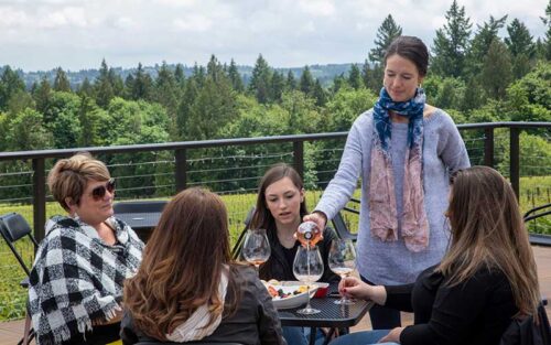 a group of women, outside, enjoying a wine tasting