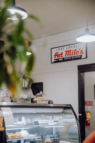 Sign and deli case at Fat Milos