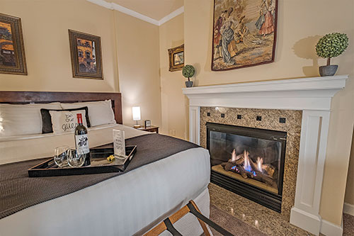 an image of a hotel room with a big bed and fireplace