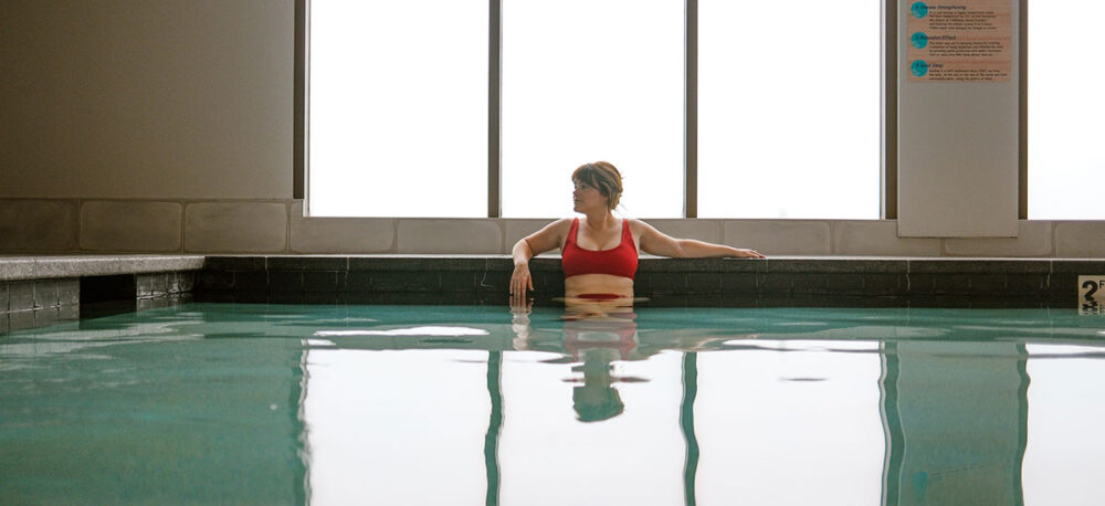 image of a woman soaking in a onsen pool