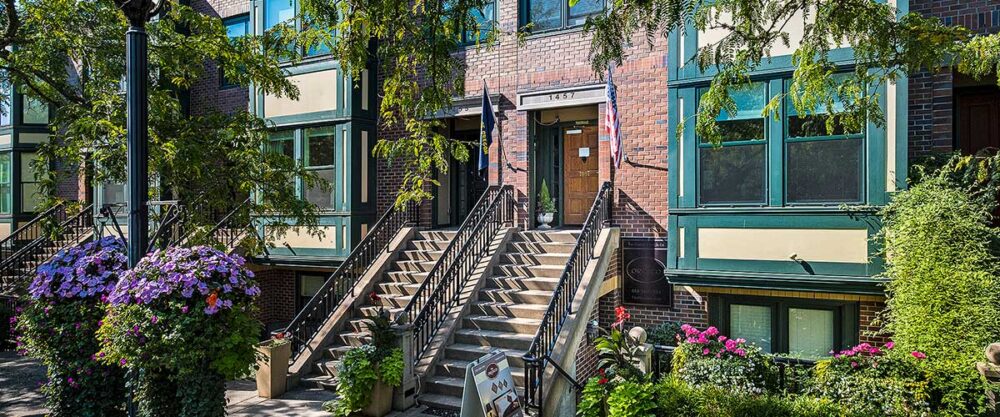 an image of green trees and plants outside of a brick building with stairs