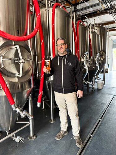 Image of a man standing in a brewery
