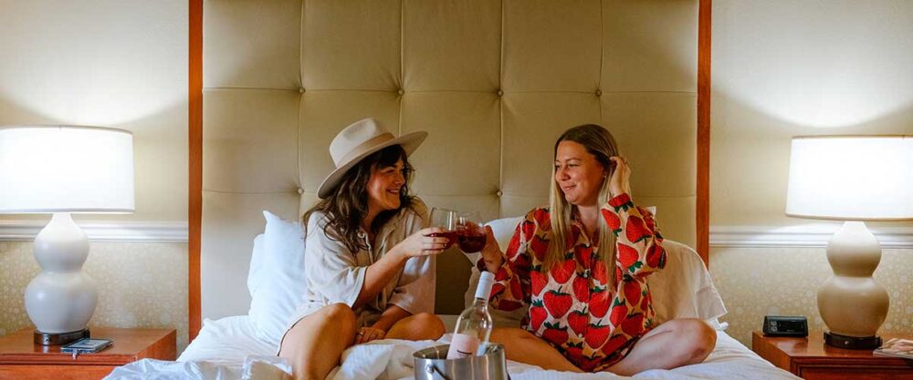 image of two friends enjoying a glass of wine